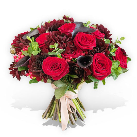 Flower bouquet with large red roses, dark pink calla lilies and red carnations